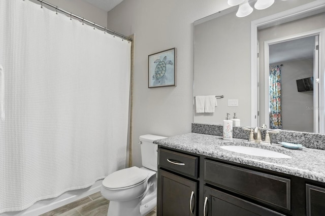 full bathroom with vanity, toilet, and shower / tub combo with curtain