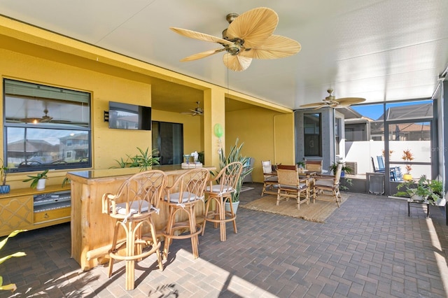 exterior space featuring bar and ceiling fan