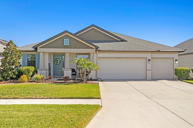 view of front of property featuring a garage and a front yard