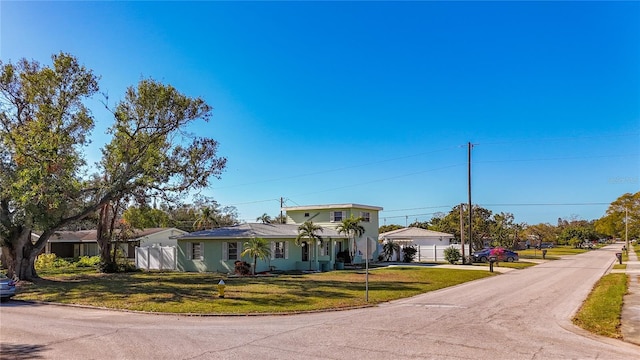 view of front of house with a front yard and a garage