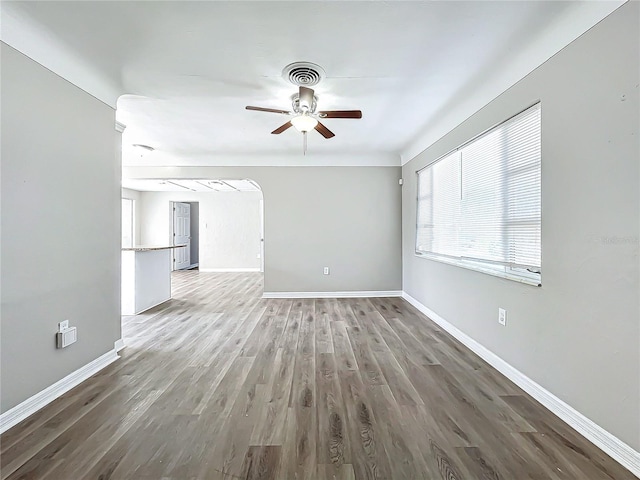 unfurnished living room featuring wood-type flooring and ceiling fan