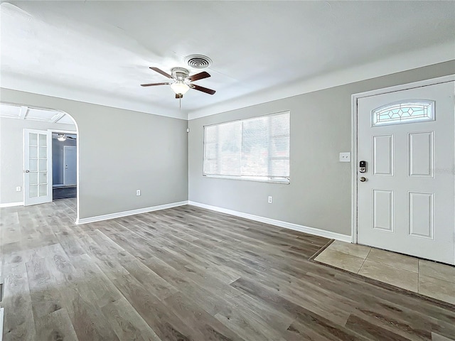 foyer with ceiling fan, hardwood / wood-style floors, and french doors