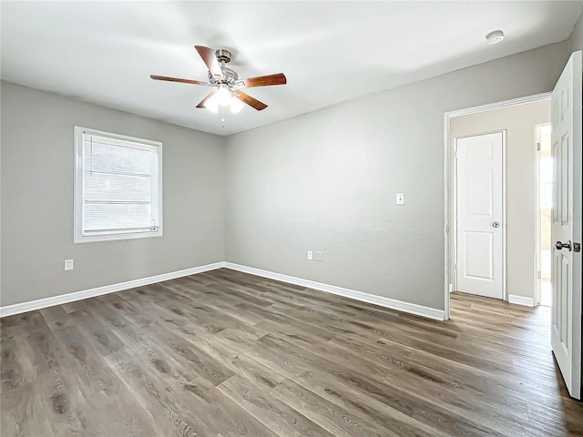 empty room featuring ceiling fan and dark wood-type flooring