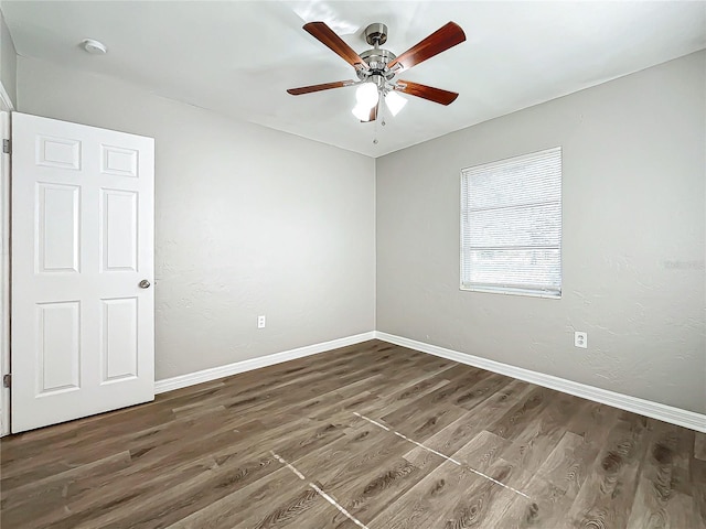 empty room featuring ceiling fan and dark hardwood / wood-style floors