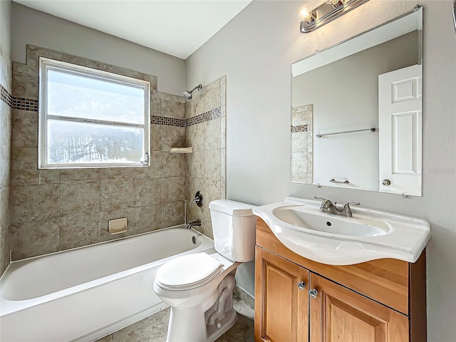 full bathroom with tile patterned flooring, tiled shower / bath combo, toilet, and vanity