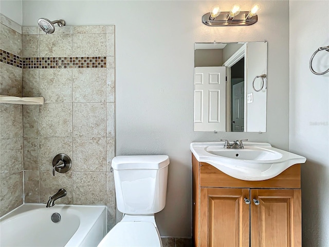 full bathroom with toilet, vanity, and tiled shower / bath