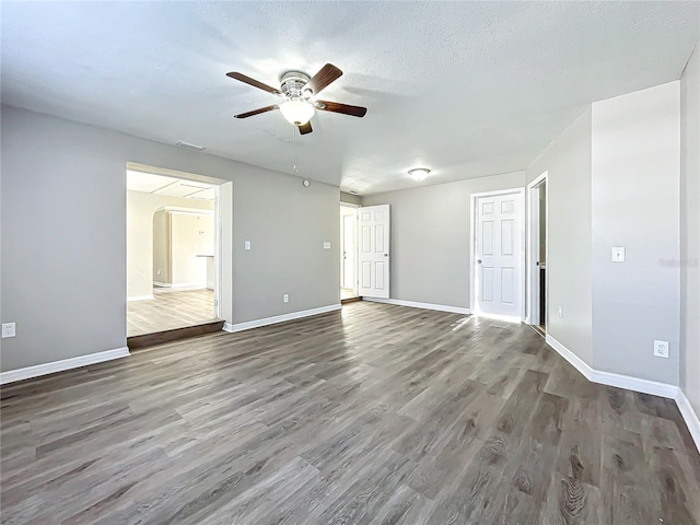 unfurnished room featuring a textured ceiling, dark hardwood / wood-style floors, and ceiling fan