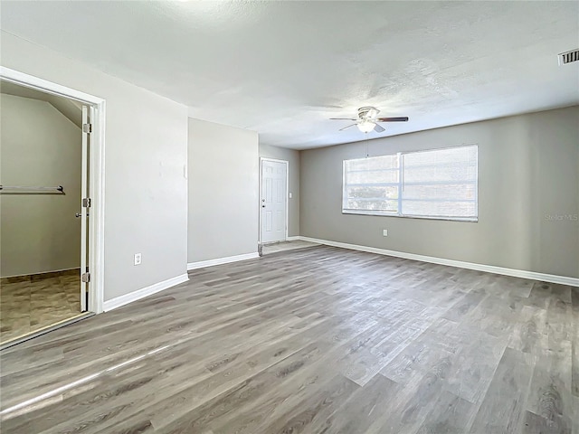 unfurnished room featuring hardwood / wood-style floors, a textured ceiling, and ceiling fan