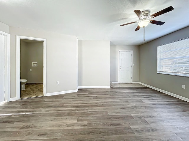 spare room featuring hardwood / wood-style flooring and ceiling fan