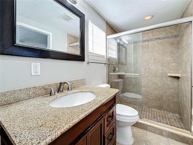 bathroom with walk in shower, tile patterned flooring, vanity, and toilet