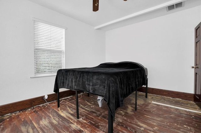 bedroom featuring multiple windows, dark hardwood / wood-style floors, and ceiling fan