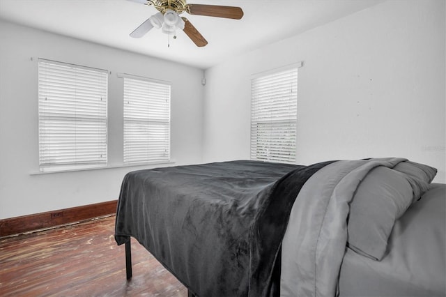 bedroom featuring ceiling fan and dark wood-type flooring