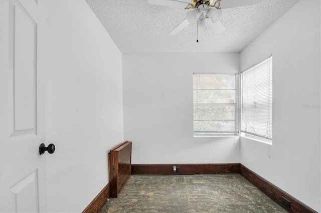 spare room featuring ceiling fan and a textured ceiling