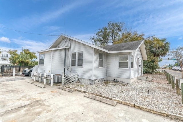 view of property exterior with central AC unit and a patio area