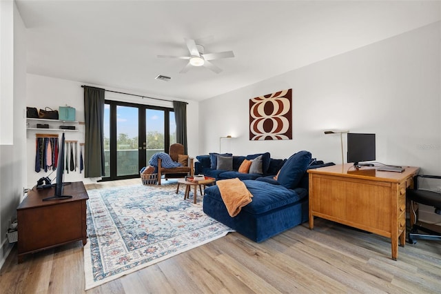 living room featuring light hardwood / wood-style floors, ceiling fan, and french doors