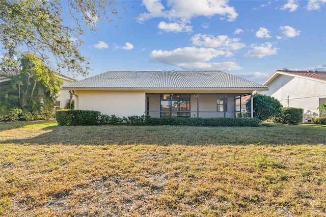 rear view of property featuring a yard