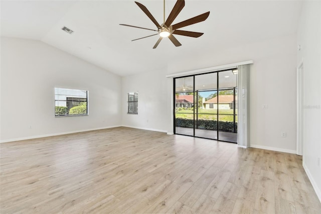 empty room featuring vaulted ceiling, ceiling fan, and light hardwood / wood-style flooring