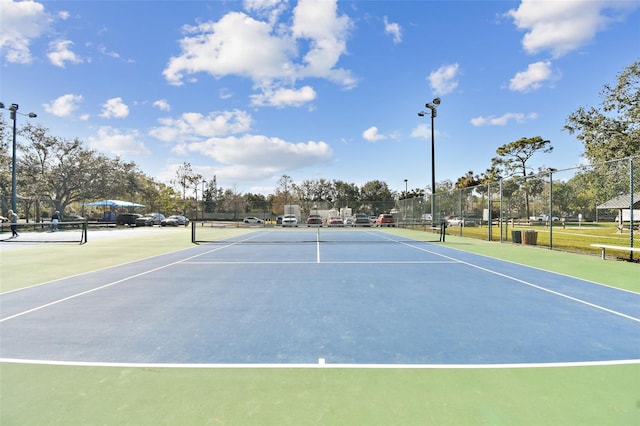 view of tennis court featuring basketball hoop