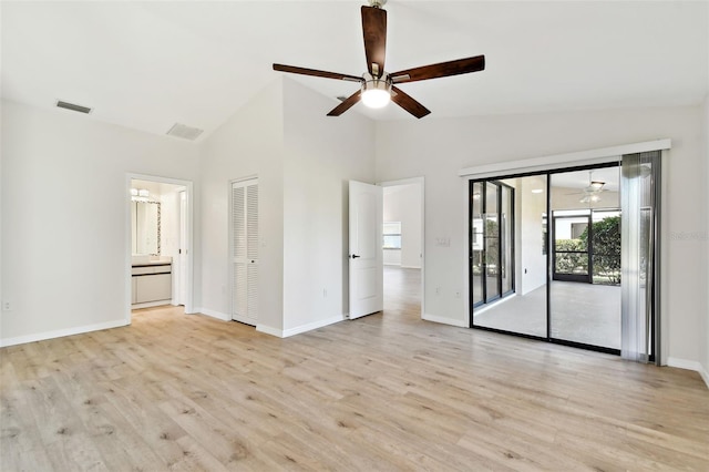 empty room with vaulted ceiling, ceiling fan, and light wood-type flooring