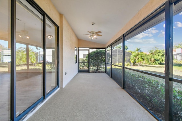 unfurnished sunroom with lofted ceiling and ceiling fan