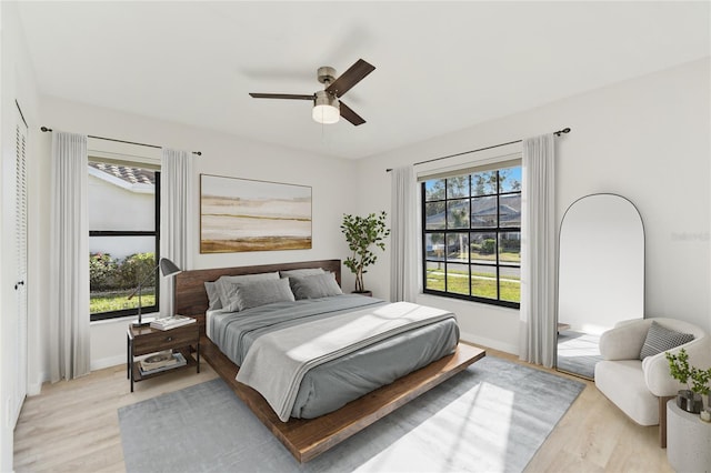 bedroom featuring light wood-type flooring and ceiling fan