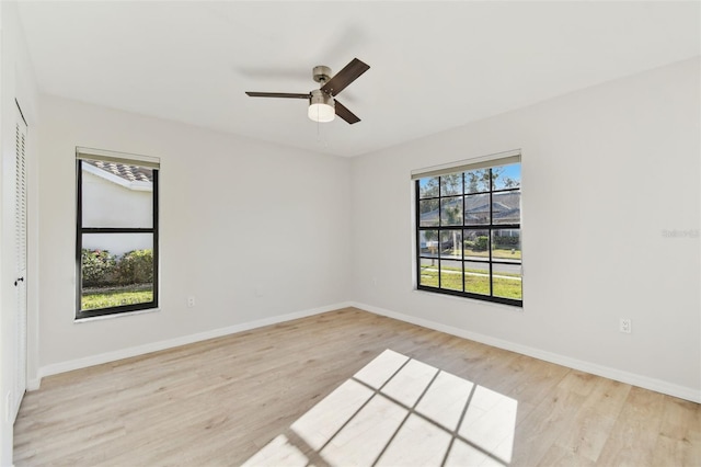 spare room with light hardwood / wood-style flooring and ceiling fan