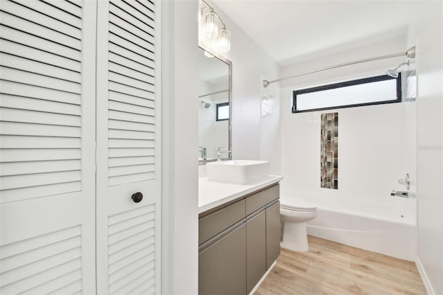 full bathroom featuring vanity, shower / bathing tub combination, hardwood / wood-style floors, and toilet