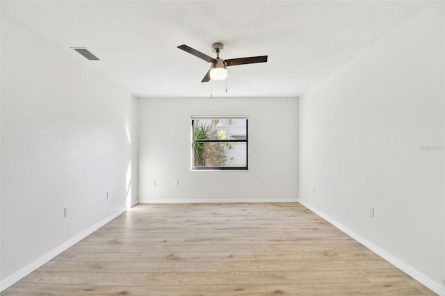 empty room with ceiling fan and light hardwood / wood-style floors