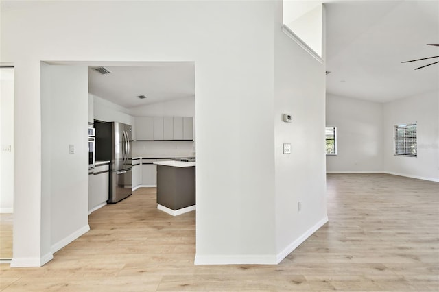 interior space featuring vaulted ceiling and light wood-type flooring