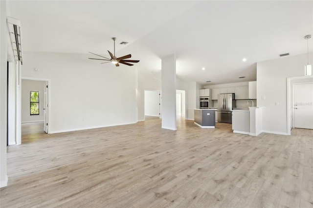 unfurnished living room with ceiling fan, lofted ceiling, and light hardwood / wood-style floors