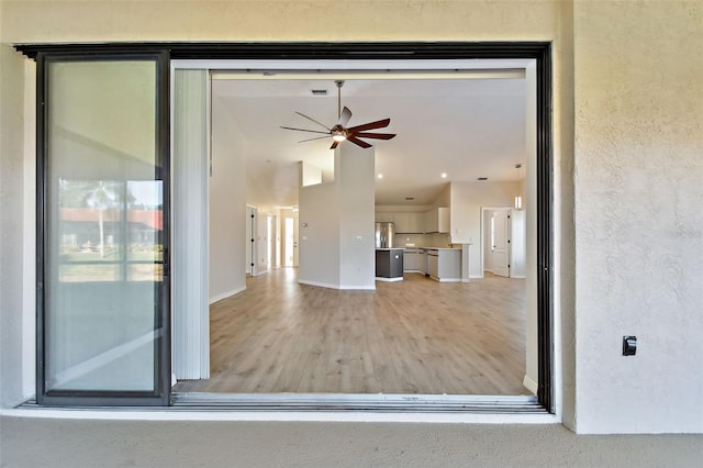 unfurnished living room with ceiling fan