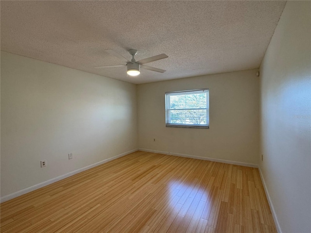 empty room with ceiling fan, light hardwood / wood-style floors, and a textured ceiling