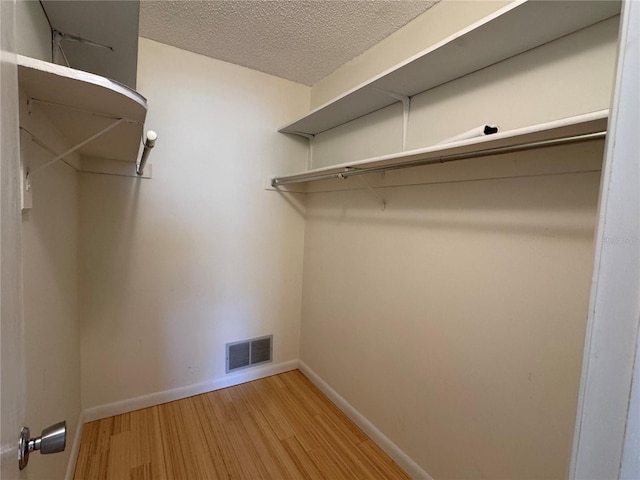 spacious closet featuring hardwood / wood-style flooring