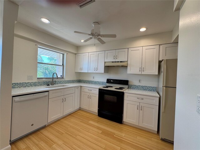 kitchen featuring sink, white appliances, ceiling fan, light hardwood / wood-style floors, and white cabinets