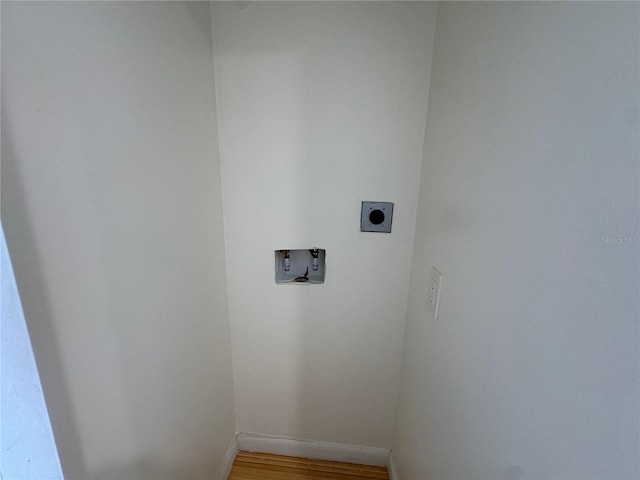 laundry area featuring hookup for a washing machine, electric dryer hookup, and hardwood / wood-style floors