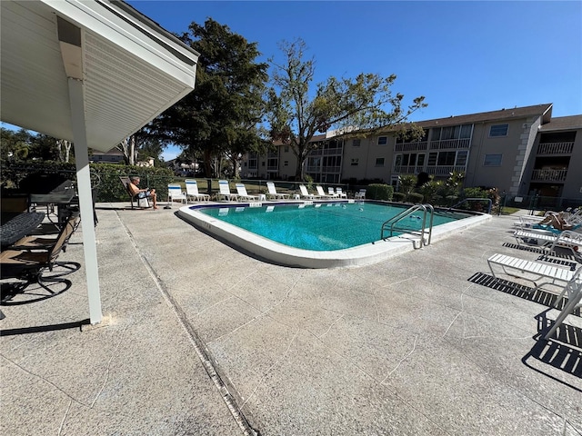 view of swimming pool featuring a patio area