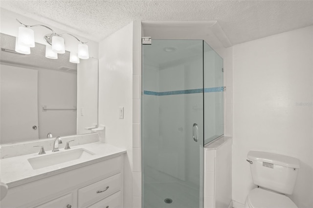 bathroom featuring vanity, toilet, an enclosed shower, and a textured ceiling