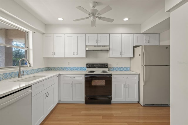 kitchen with sink, white cabinets, ceiling fan, light hardwood / wood-style floors, and white appliances