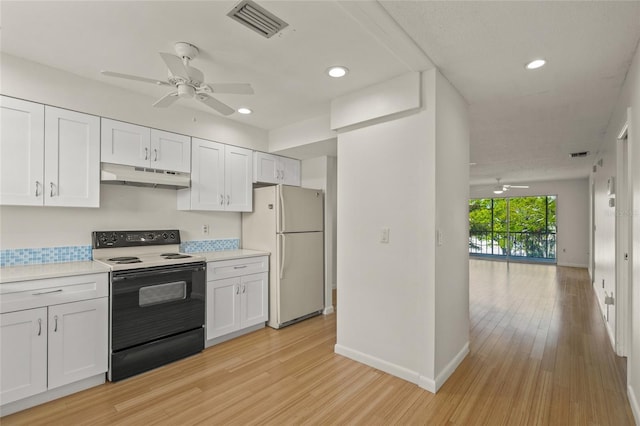 kitchen featuring white refrigerator, white cabinetry, light hardwood / wood-style flooring, and electric stove