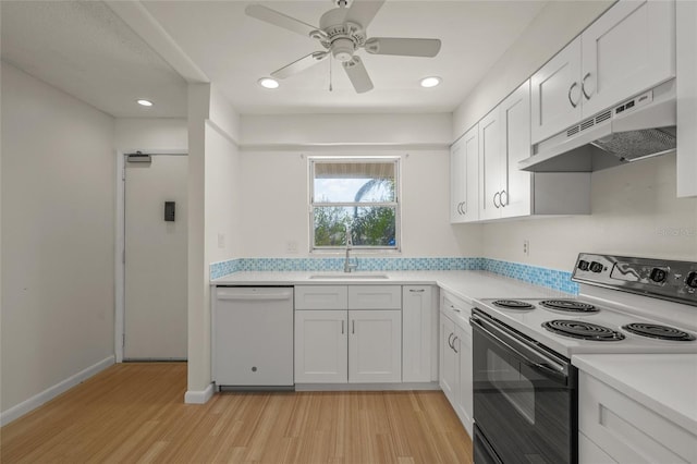 kitchen with dishwasher, sink, white cabinets, and electric stove