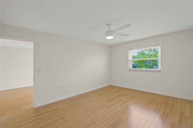 unfurnished room with ceiling fan, a textured ceiling, and light wood-type flooring