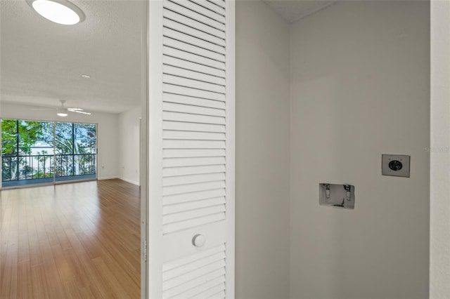 clothes washing area featuring light hardwood / wood-style flooring, ceiling fan, hookup for a washing machine, a textured ceiling, and hookup for an electric dryer