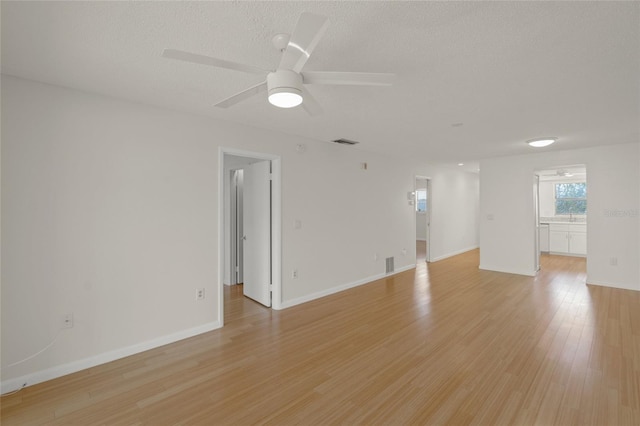 3987 Maceachen Blvd Unit 133, Sarasota, FL 34233 - spare room featuring ceiling fan, light wood-style floors, a textured ceiling, baseboards, and visible vents