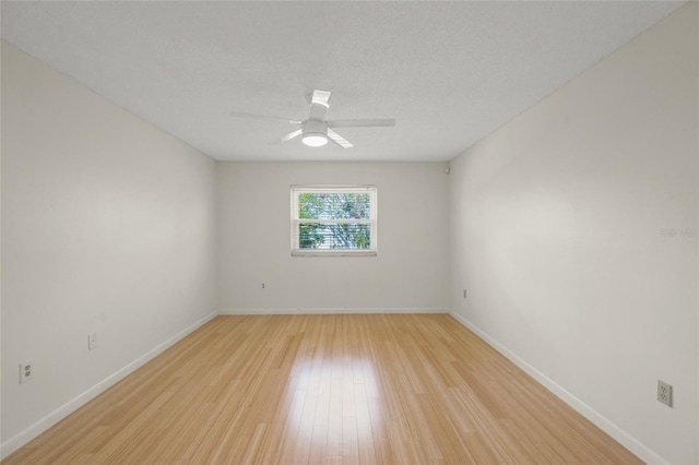 3987 Maceachen Blvd Unit 133, Sarasota, FL 34233 - spare room with baseboards, a ceiling fan, and light wood-type flooring