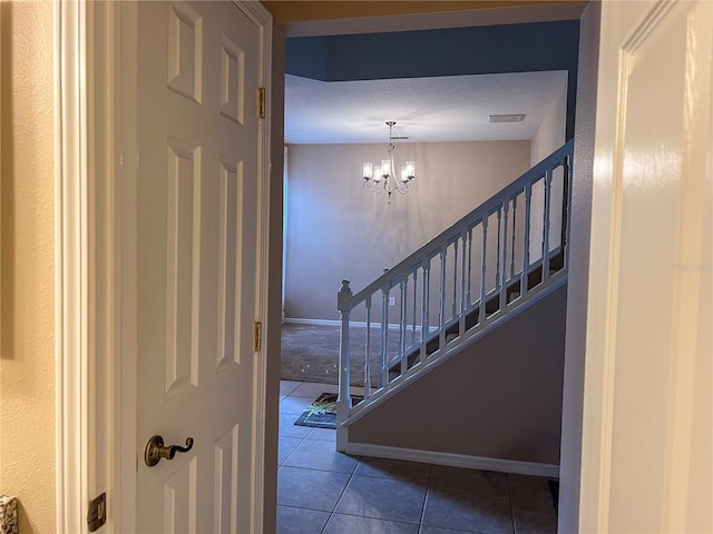 foyer entrance with a chandelier and tile patterned floors