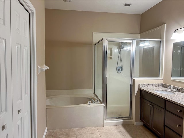 bathroom featuring vanity, tile patterned floors, and separate shower and tub