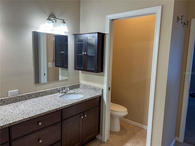 bathroom with tile patterned floors, vanity, and toilet