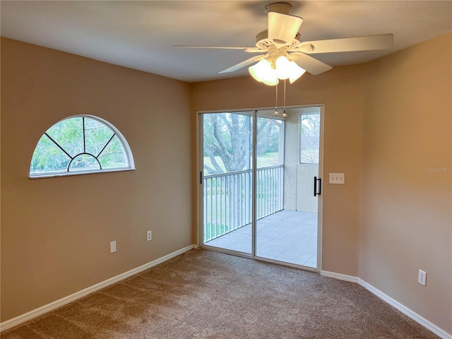 empty room featuring ceiling fan and light carpet