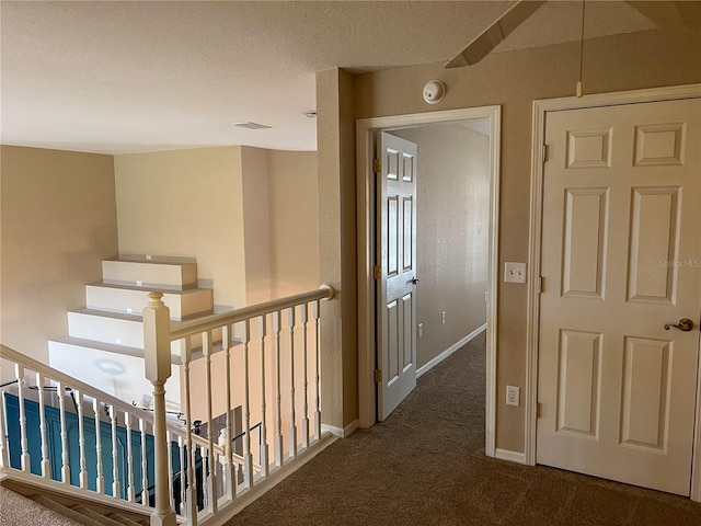 corridor with dark colored carpet