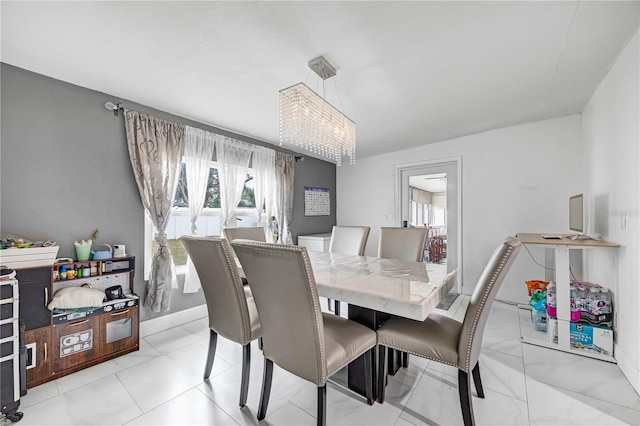 dining area with a notable chandelier and a wealth of natural light